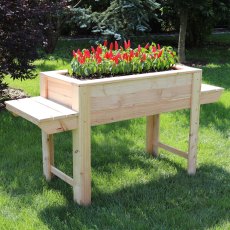 Shire Dim Larchwood Planter - in situ, angle view, flowers